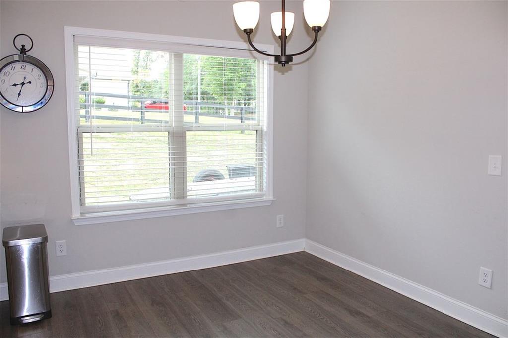 728 Harmony Road Temple, GA 30179 - Photo 13 of 29 an empty room with wooden floor and windows