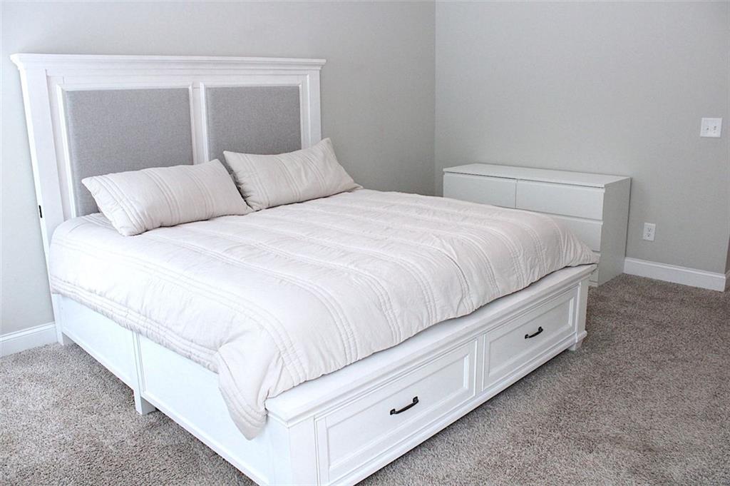 728 Harmony Road Temple, GA 30179 - Photo 15 of 29 a bedroom with a bed and a night stand