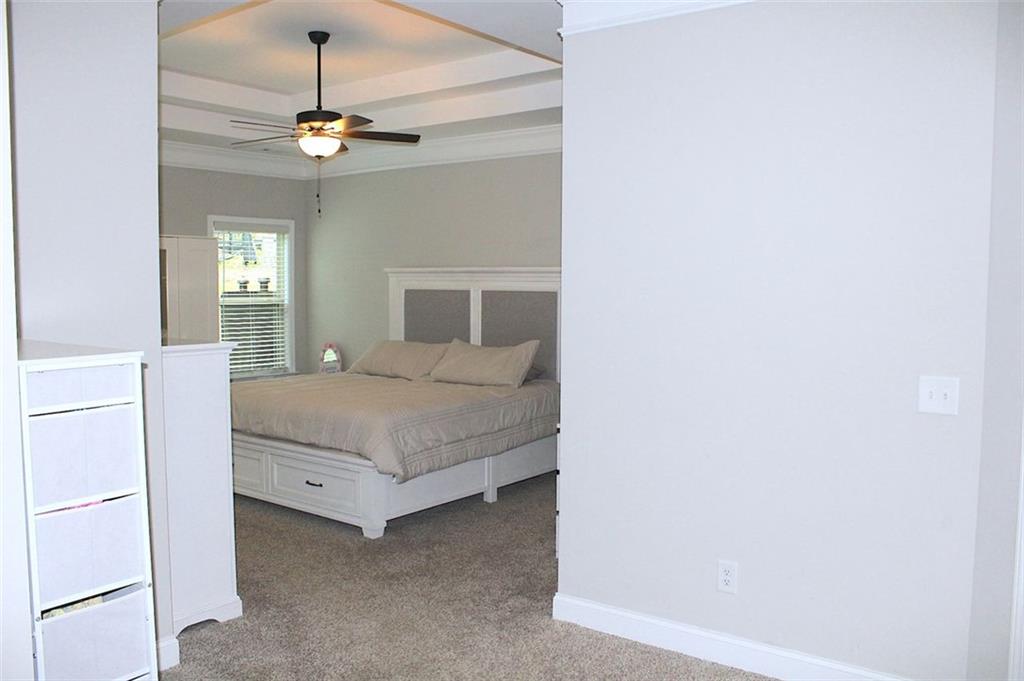 728 Harmony Road Temple, GA 30179 - Photo 18 of 29 a bedroom with a bed and a chandelier