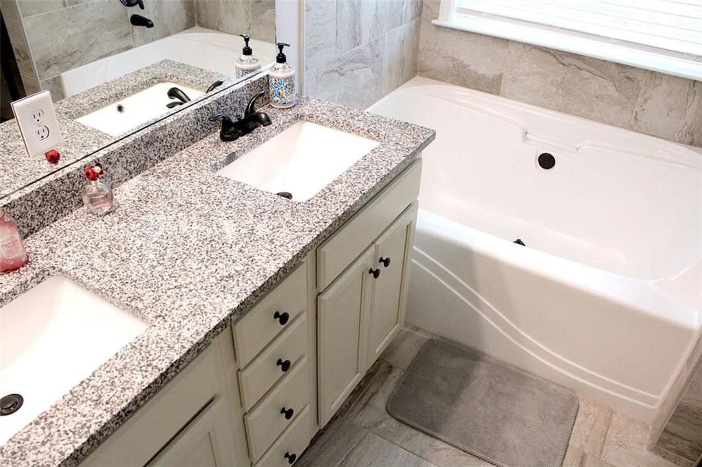 728 Harmony Road Temple, GA 30179 - Photo 20 of 29 a bathroom with a granite countertop sink and a tub