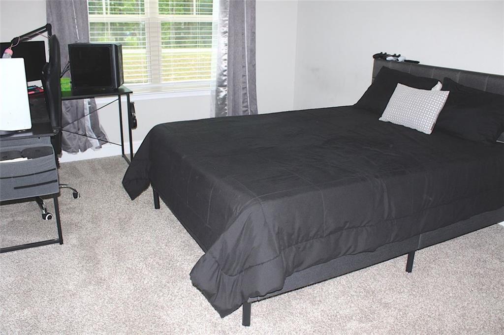 728 Harmony Road Temple, GA 30179 - Photo 26 of 29 a bed sitting in a bedroom next to a window
