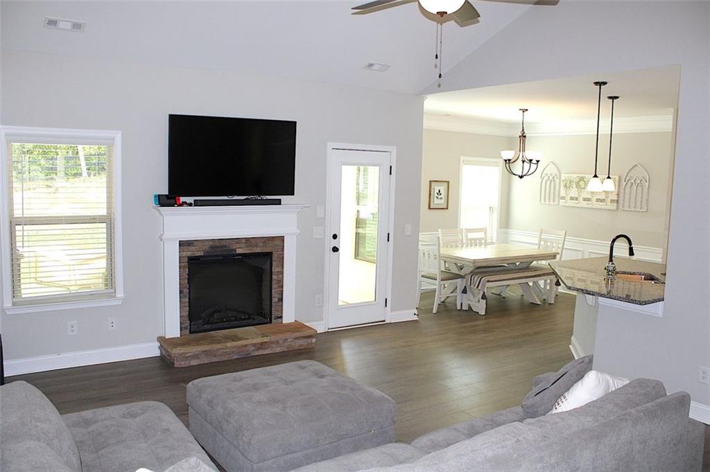 728 Harmony Road Temple, GA 30179 - Photo 7 of 29 a living room with furniture a flat screen tv and a fireplace