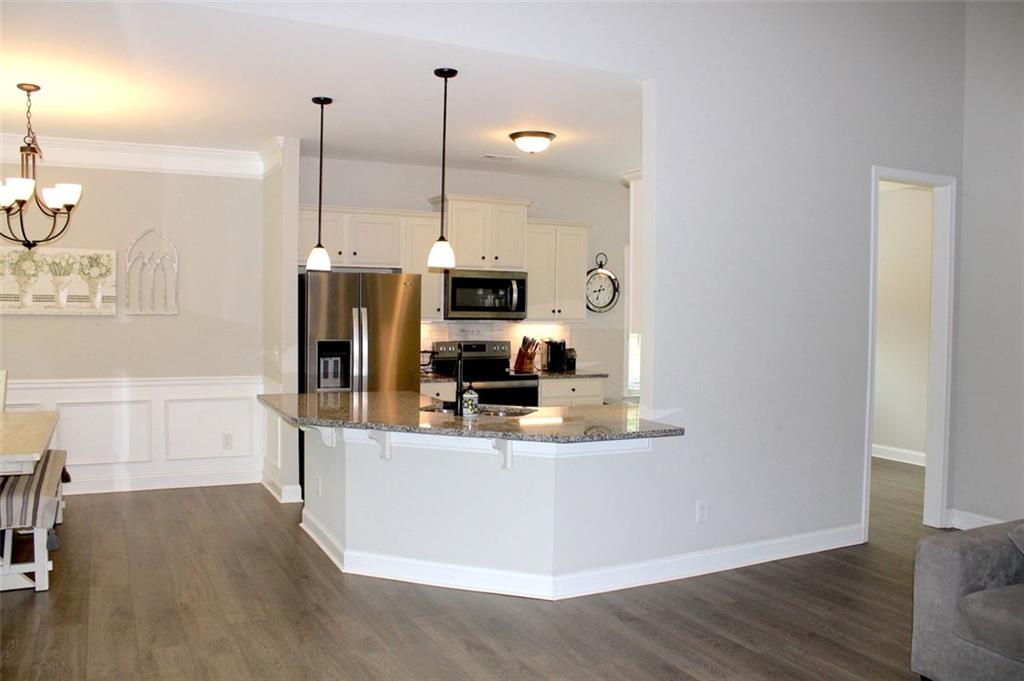 728 Harmony Road Temple, GA 30179 - Photo 9 of 29 a view of a kitchen with kitchen island a counter top space stainless steel appliances and wooden floor