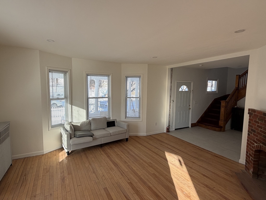 12 Stoneland Road Worcester, MA 01603 - Photo 11 of 36 a living room with furniture and a wooden floor