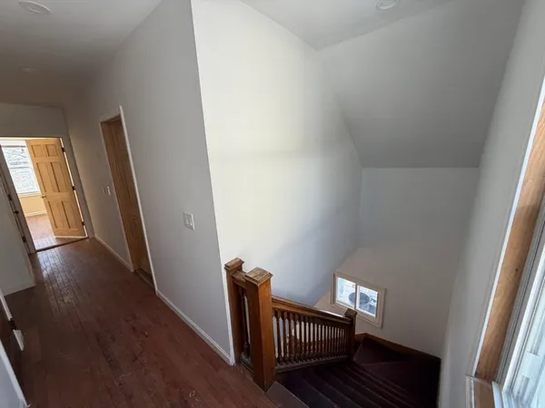 a view of hallway with wooden floor