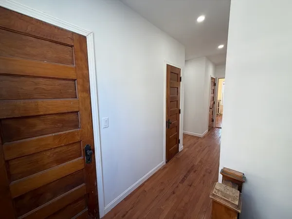 a view of hallway with wooden floor