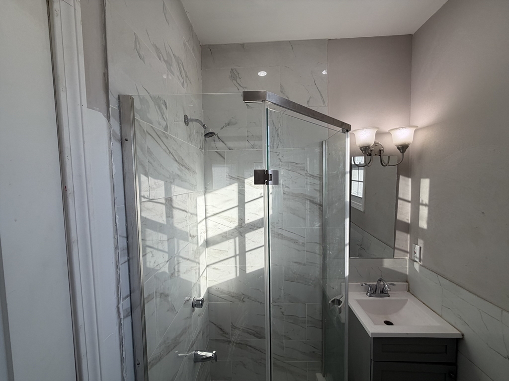12 Stoneland Road Worcester, MA 01603 - Photo 2 of 36 a bathroom with a shower and a sink
