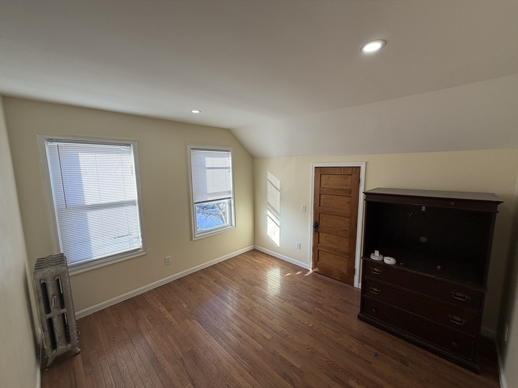 12 Stoneland Road Worcester, MA 01603 - Photo 22 of 36 a view of an empty room with wooden floor and a window