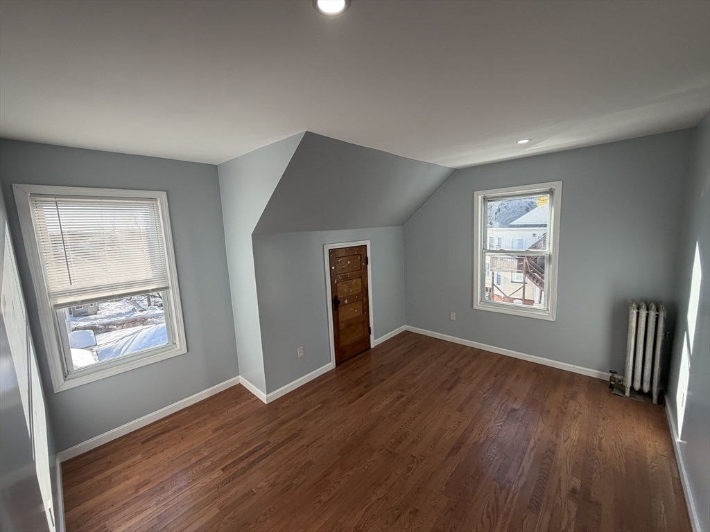 12 Stoneland Road Worcester, MA 01603 - Photo 25 of 36 a view of an empty room with window and wooden floor