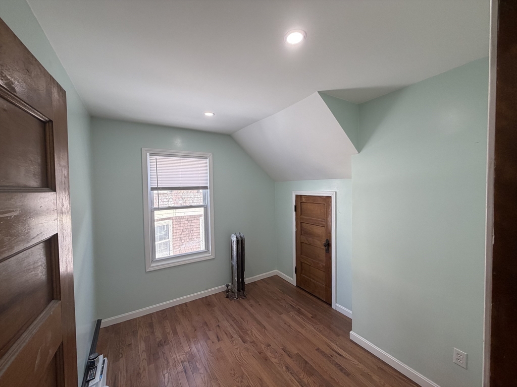 12 Stoneland Road Worcester, MA 01603 - Photo 27 of 36 an empty room with wooden floor and windows