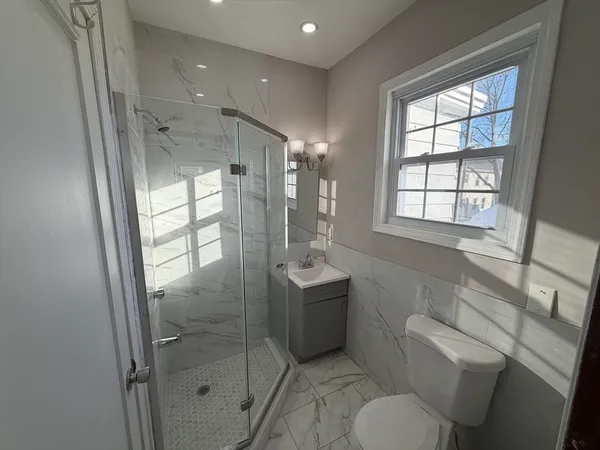 a bathroom with a toilet sink and shower