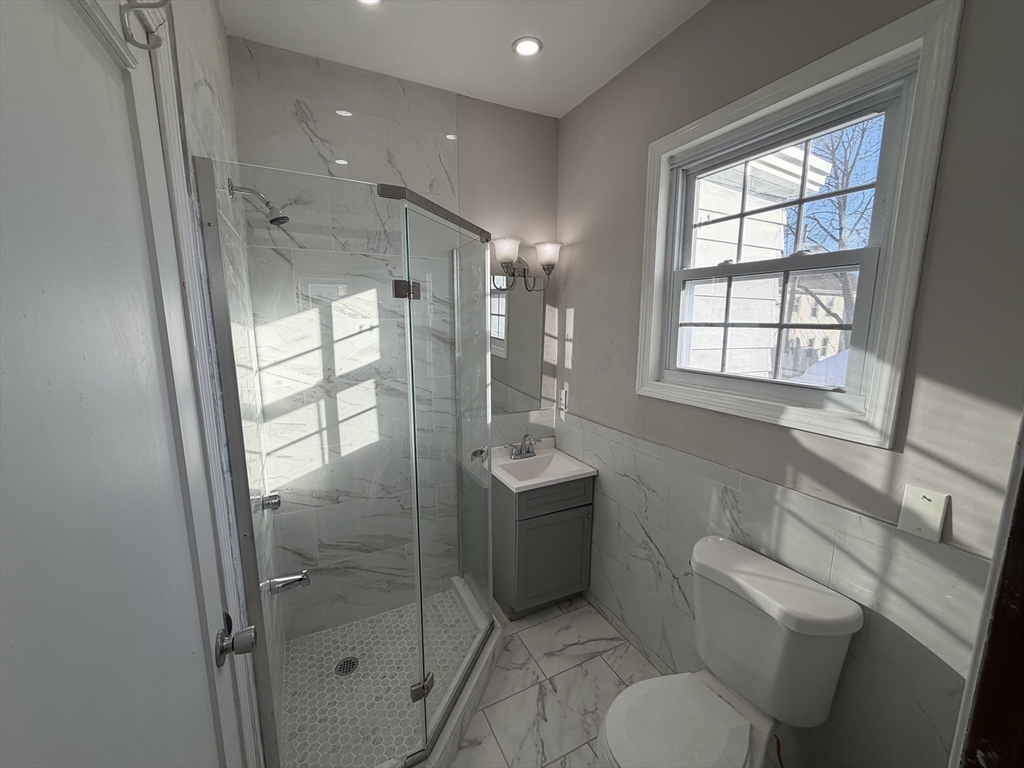 12 Stoneland Road Worcester, MA 01603 - Photo 3 of 36 a bathroom with a toilet sink and shower