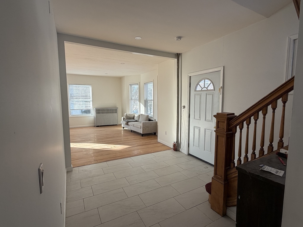 12 Stoneland Road Worcester, MA 01603 - Photo 7 of 36 a view of a livingroom with wooden floor and stairs