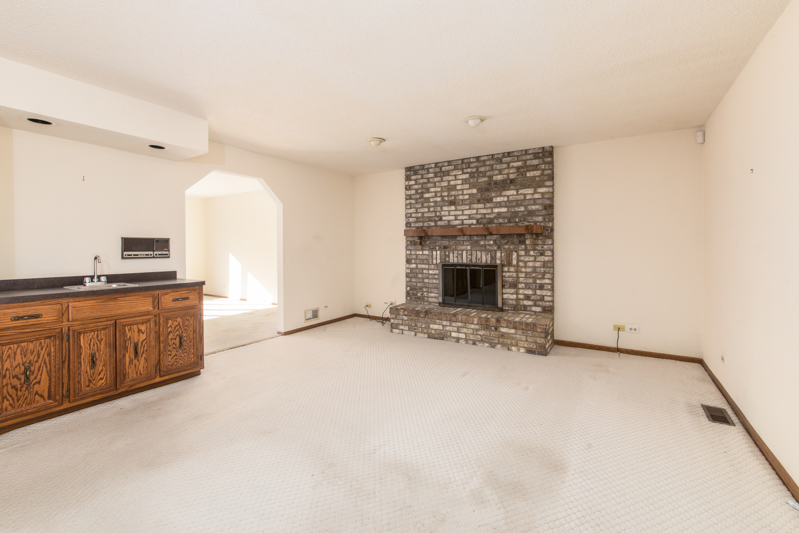 1414 West Talcott Road Park Ridge, IL 60068 - Photo 10 of 41 a view of an empty room with a fireplace and a window