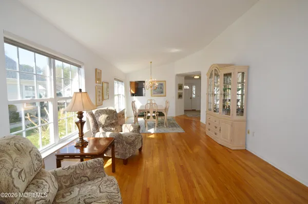 a view of a room with wooden floor and a sink