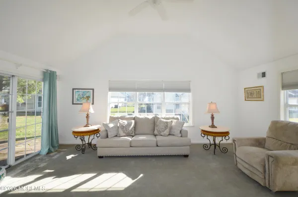 a living room with furniture window and a table