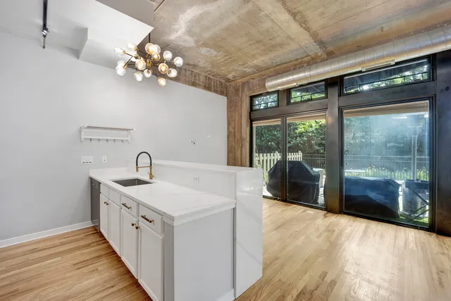 a large white kitchen with a large window
