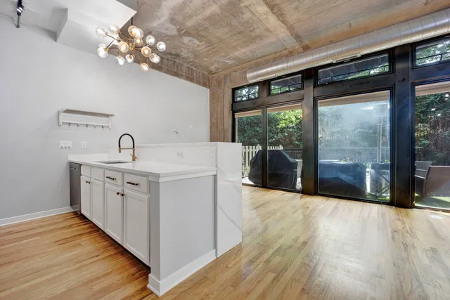a large white kitchen with a large window