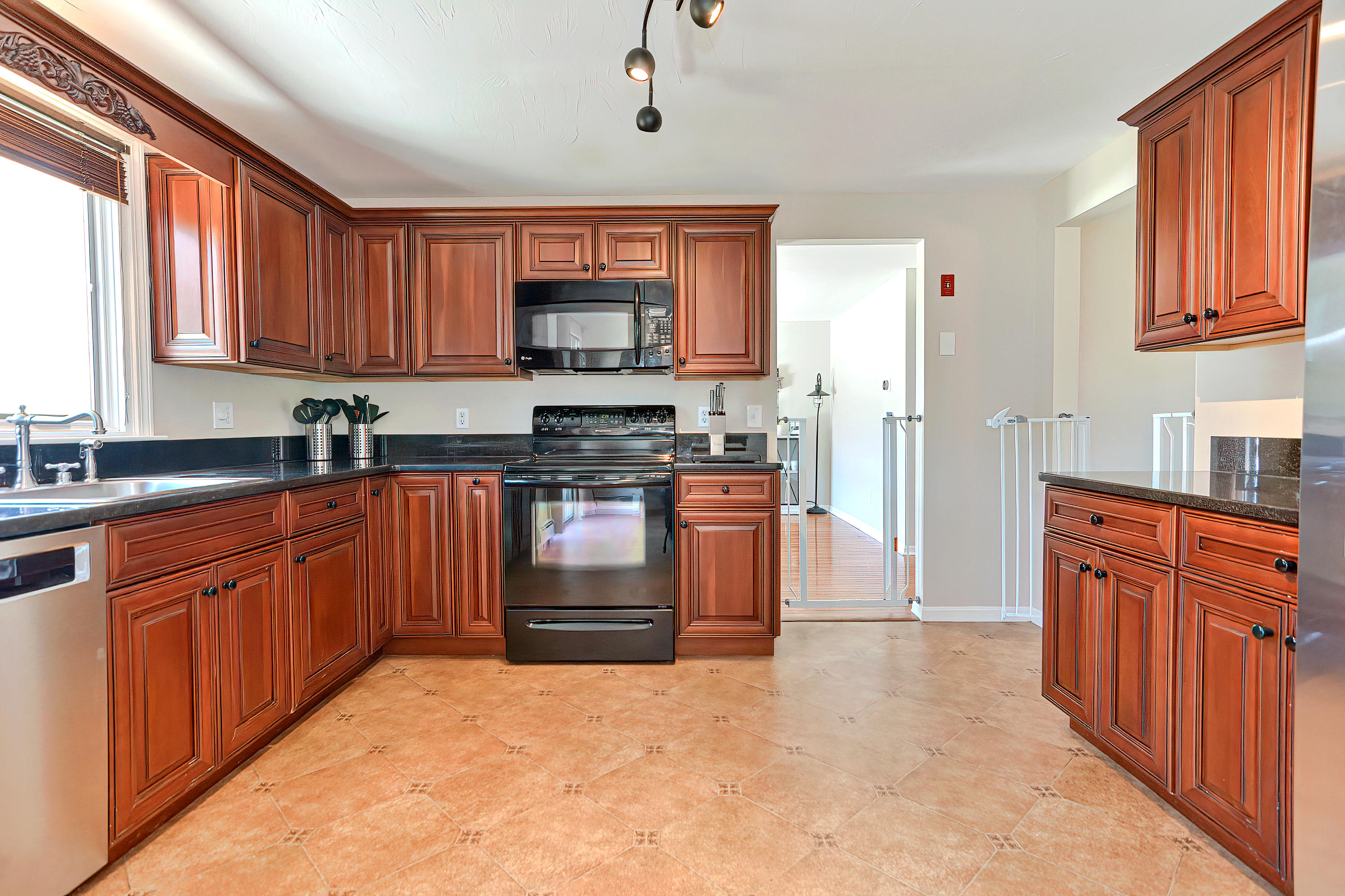 7 Wellfield Road Forestdale, MA 02644 - Photo 14 of 42 a kitchen with stainless steel appliances granite countertop a stove top oven a sink dishwasher and a refrigerator with wooden cabinets