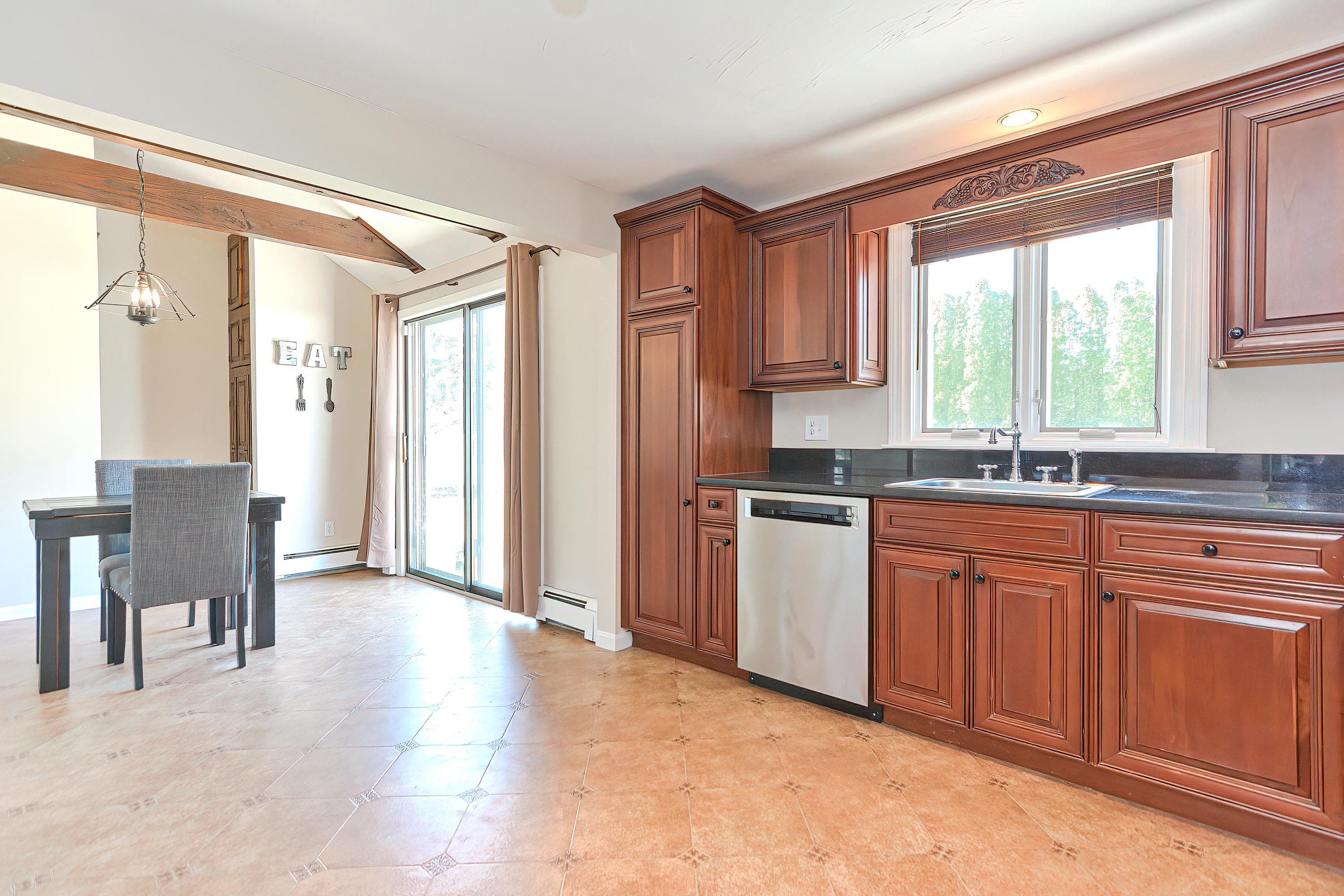 7 Wellfield Road Forestdale, MA 02644 - Photo 16 of 42 a kitchen with granite countertop a refrigerator and wooden cabinets