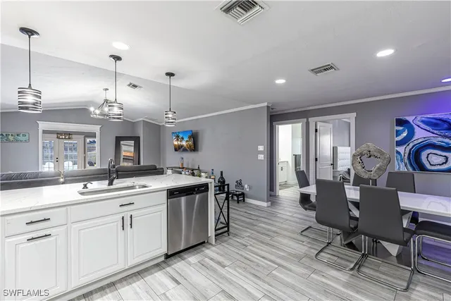 a kitchen with stainless steel appliances a refrigerator sink and cabinets