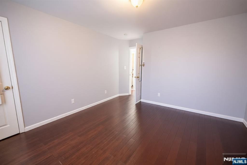 289 Rose Street Newark, NJ 07108 - Photo 15 of 29 a view of an empty room with wooden floor