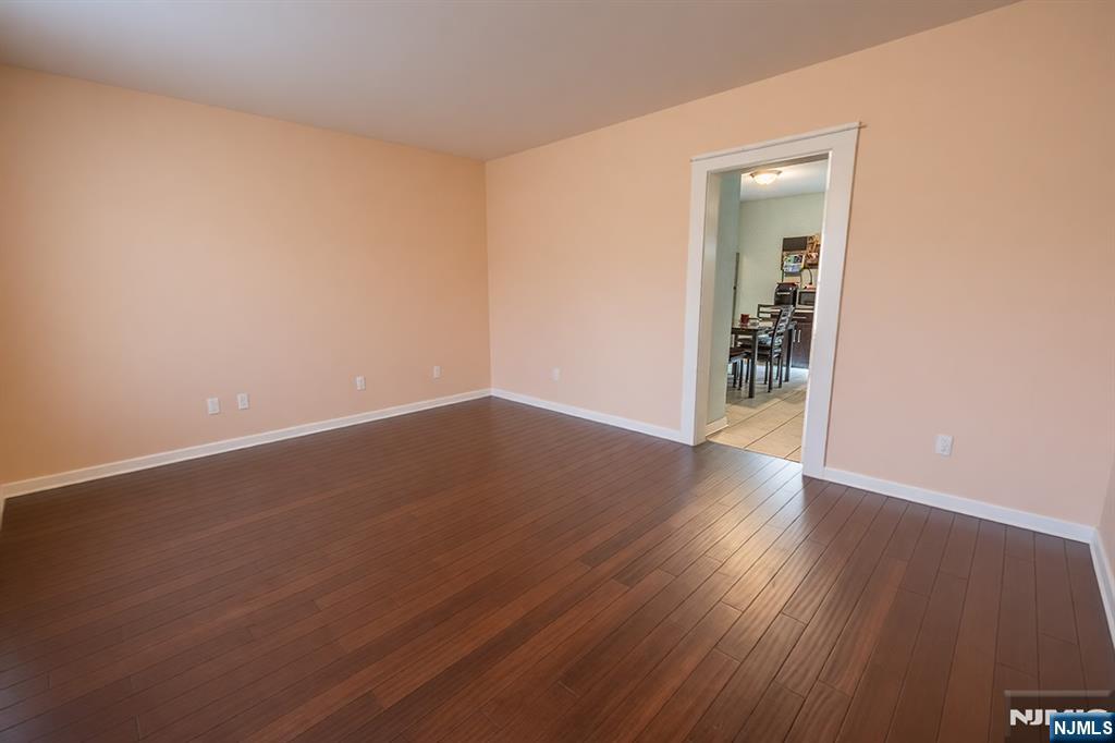 289 Rose Street Newark, NJ 07108 - Photo 17 of 29 an empty room with wooden floor and closet