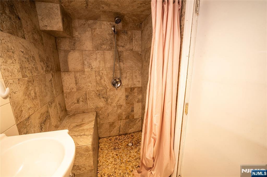 289 Rose Street Newark, NJ 07108 - Photo 18 of 29 a bathroom with a bathtub and shower
