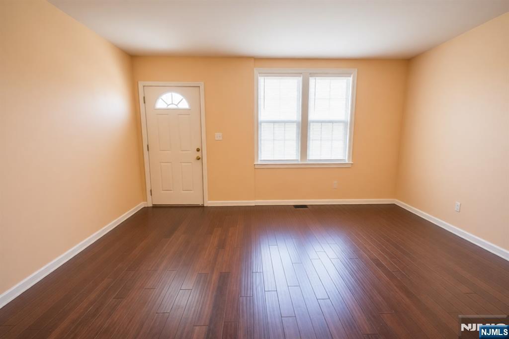 289 Rose Street Newark, NJ 07108 - Photo 4 of 29 an empty room with wooden floor and windows