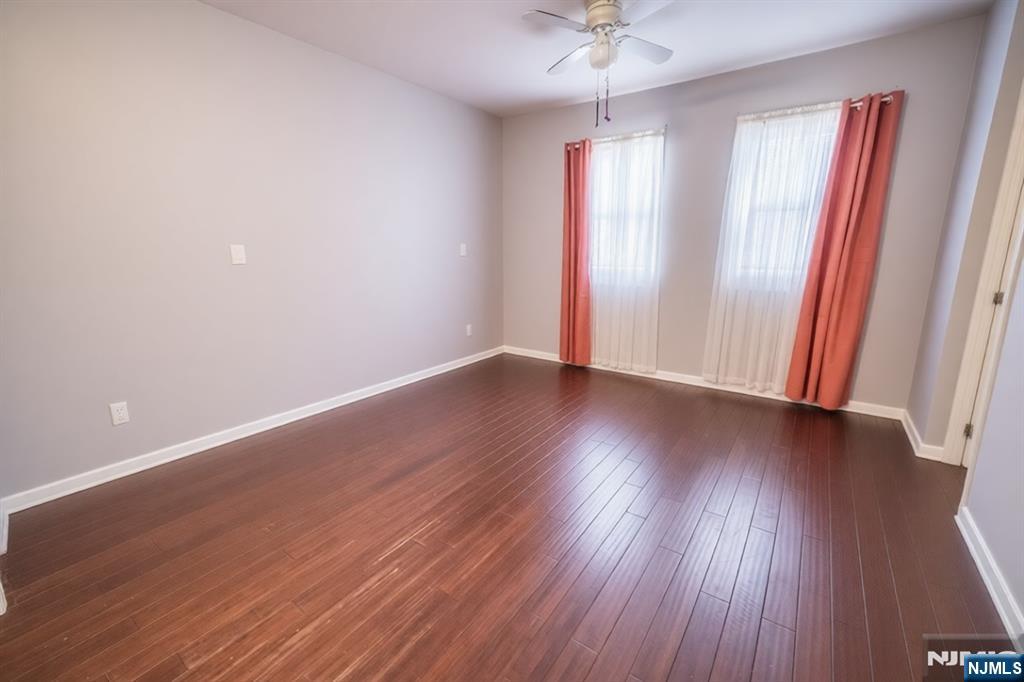 289 Rose Street Newark, NJ 07108 - Photo 5 of 29 an empty room with wooden floor and window