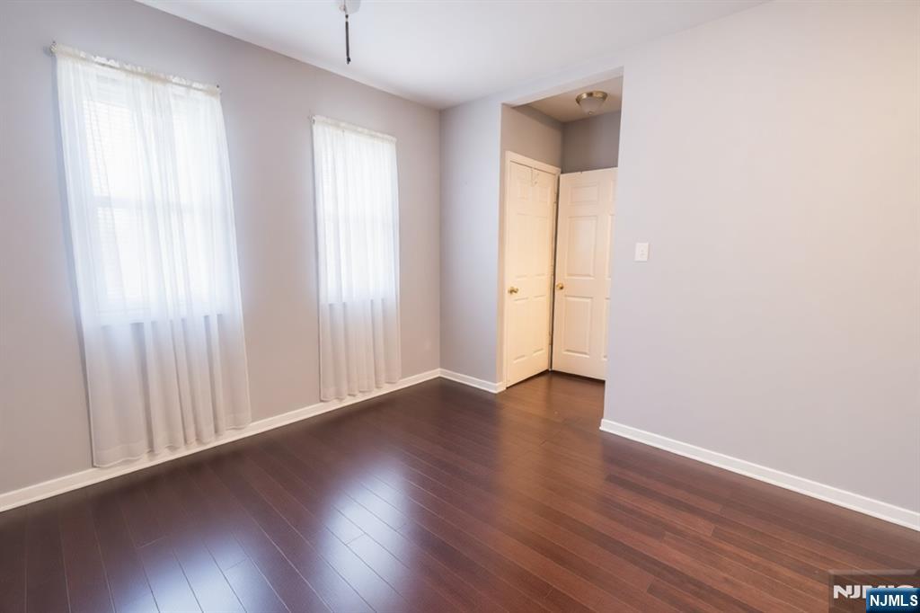 289 Rose Street Newark, NJ 07108 - Photo 6 of 29 an empty room with wooden floor and windows