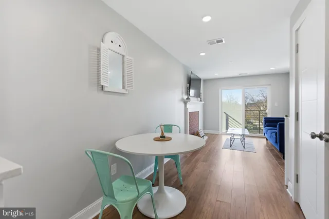 a dining room with furniture and wooden floor