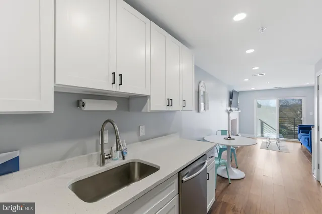 a kitchen with a sink a stove and cabinets