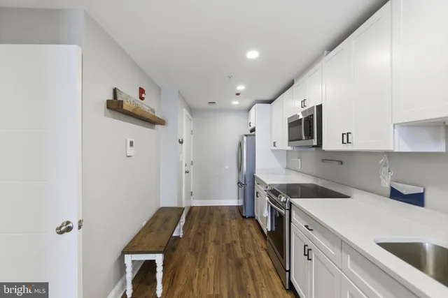 a kitchen with a stove and a refrigerator