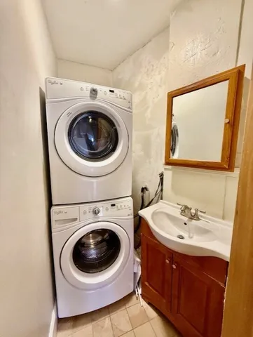 a utility room with sink dryer and washer