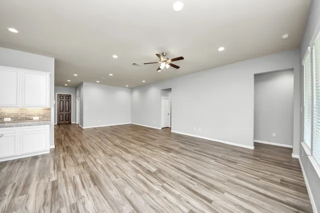 a view of kitchen and kitchen with hardwood floor
