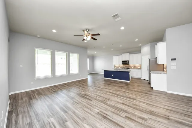 a kitchen with kitchen island stainless steel appliances a sink stove and refrigerator