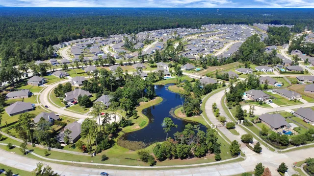 an aerial view of residential houses with outdoor space and parking