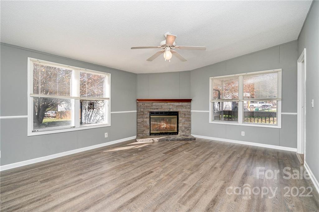 4289 Henry Dellinger Road Maiden, NC 28650 - Photo 12 of 42 wooden floor fireplace and windows in an empty room