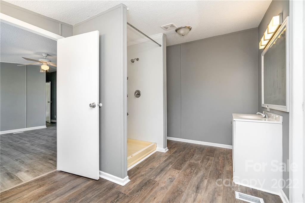 4289 Henry Dellinger Road Maiden, NC 28650 - Photo 16 of 42 a view of a room with wooden floor and a bathroom