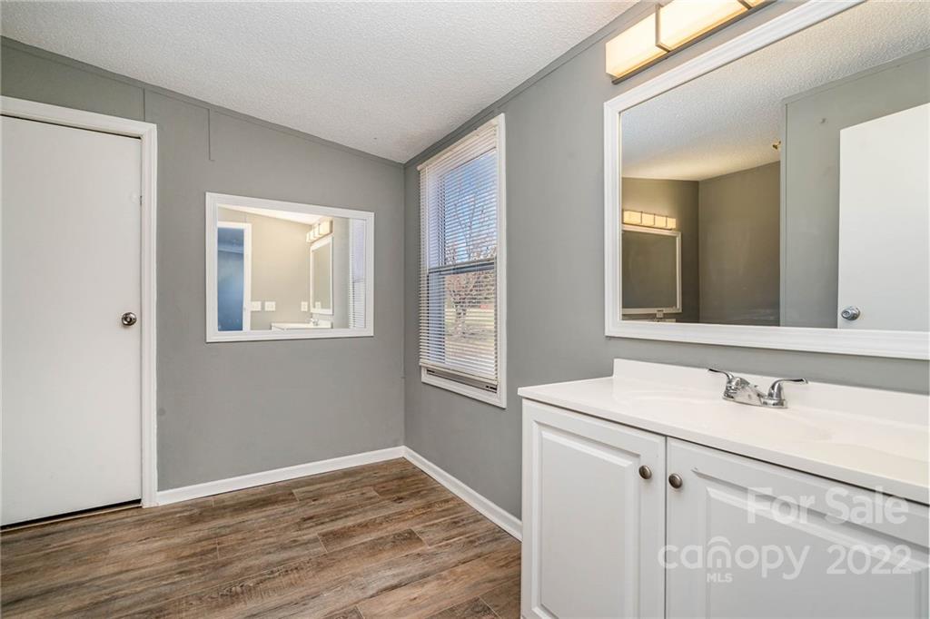 4289 Henry Dellinger Road Maiden, NC 28650 - Photo 17 of 42 a room with a sink cabinets and wooden floor