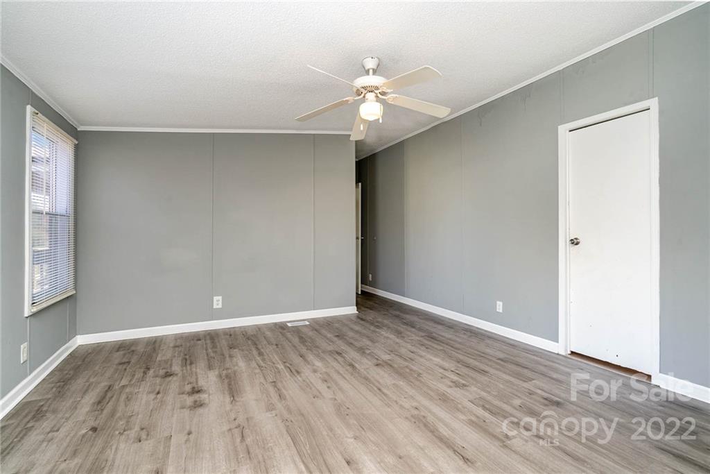 4289 Henry Dellinger Road Maiden, NC 28650 - Photo 19 of 42 a view of an empty room with wooden floor