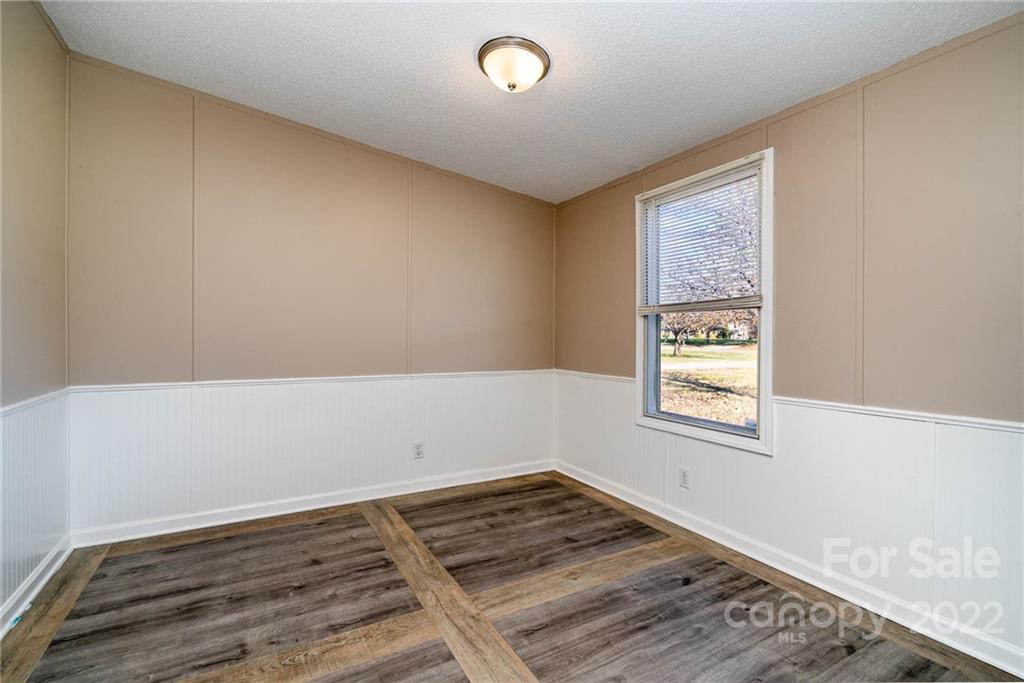 4289 Henry Dellinger Road Maiden, NC 28650 - Photo 21 of 42 an empty room with wooden floor and windows
