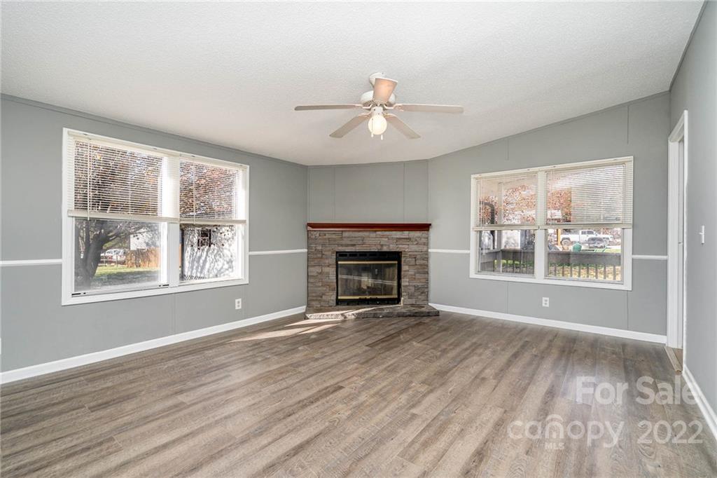 4289 Henry Dellinger Road Maiden, NC 28650 - Photo 22 of 42 wooden floor fireplace and windows in an empty room