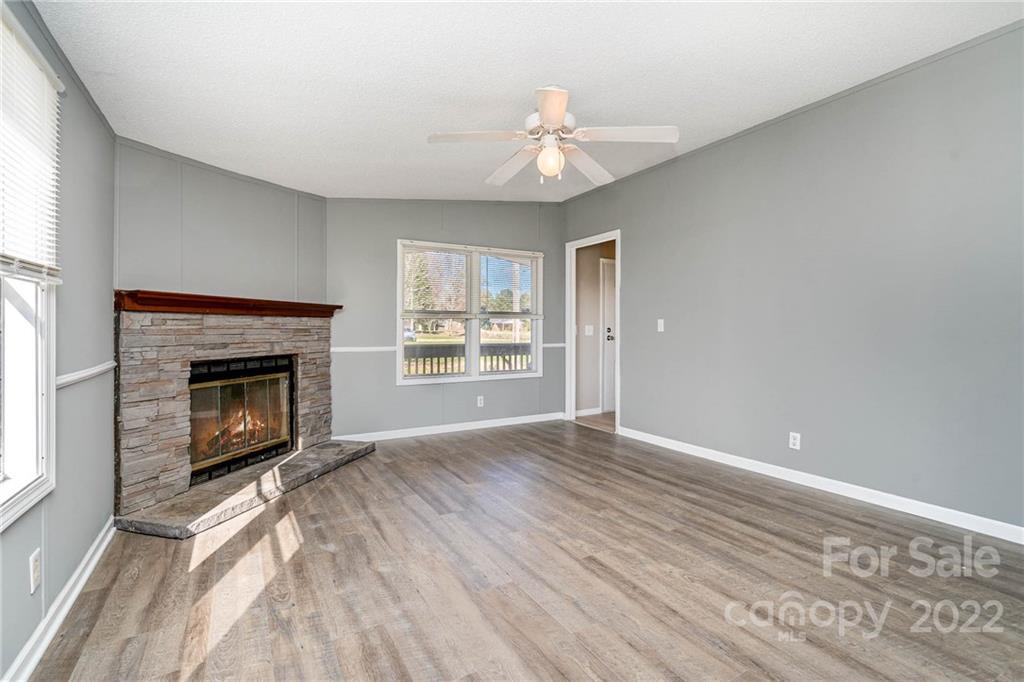 4289 Henry Dellinger Road Maiden, NC 28650 - Photo 23 of 42 a view of an empty room with wooden floor fireplace and a window