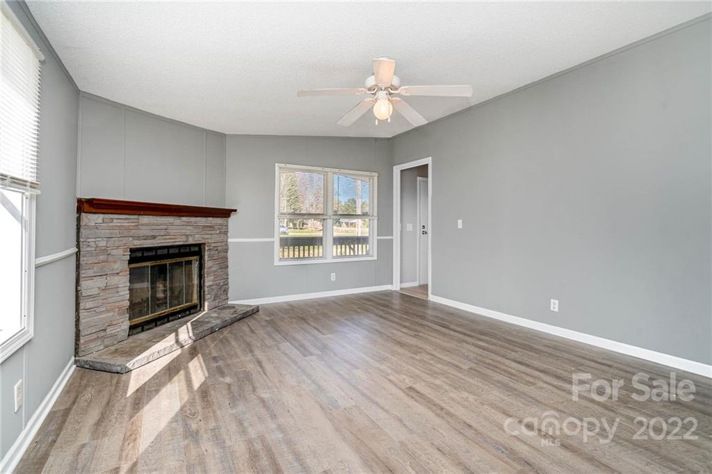 4289 Henry Dellinger Road Maiden, NC 28650 - Photo 24 of 42 a view of an empty room with wooden floor fireplace and a window