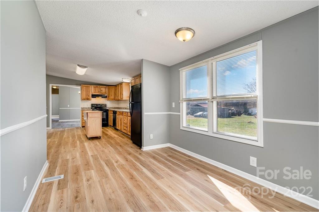 4289 Henry Dellinger Road Maiden, NC 28650 - Photo 25 of 42 a view of a kitchen with wooden floor electronic appliances and windows