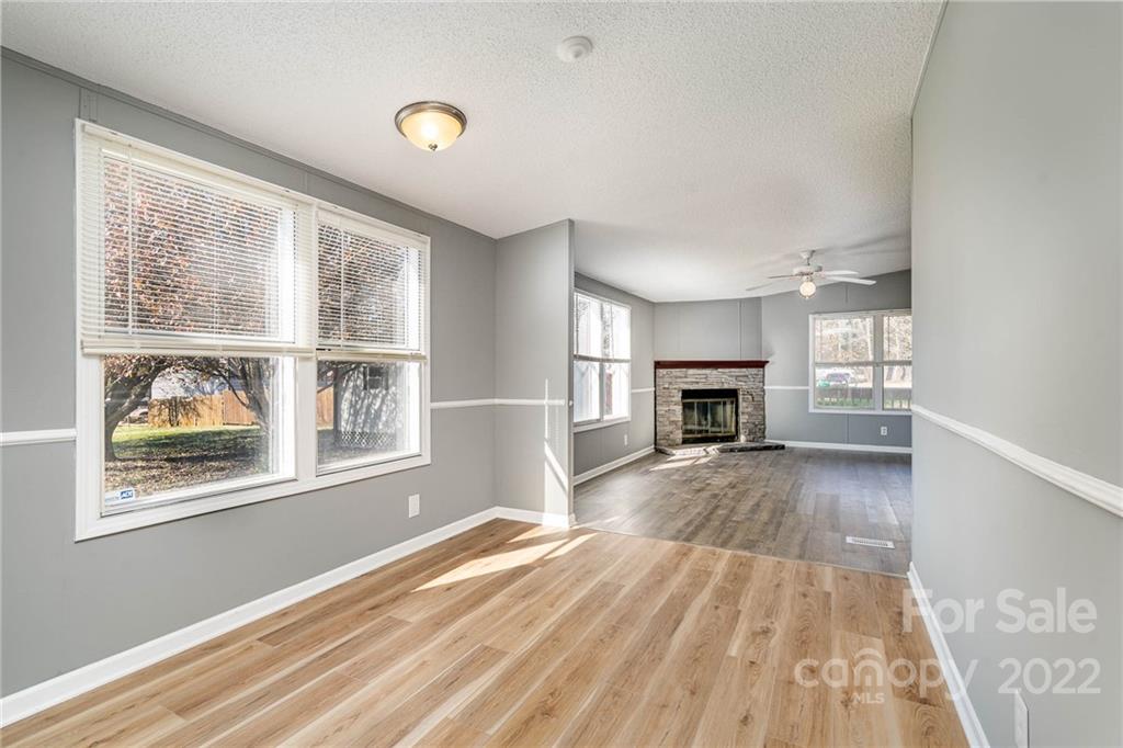 4289 Henry Dellinger Road Maiden, NC 28650 - Photo 27 of 42 a view of empty room with wooden floor and fireplace