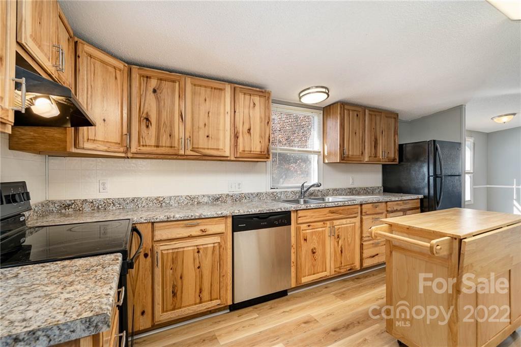 4289 Henry Dellinger Road Maiden, NC 28650 - Photo 29 of 42 a kitchen with stainless steel appliances granite countertop a sink stove and refrigerator