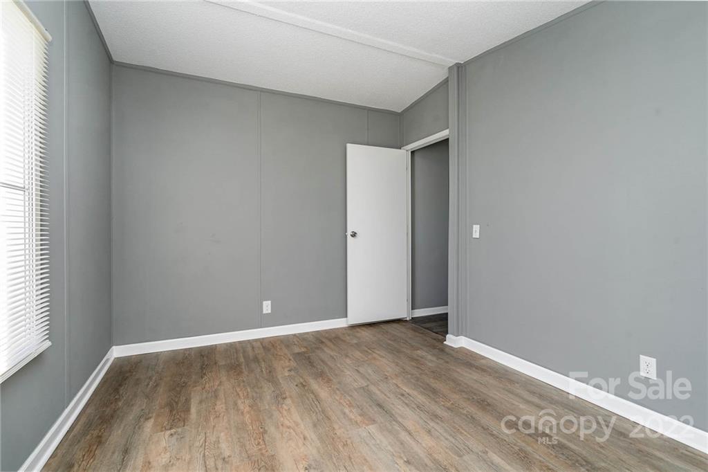 4289 Henry Dellinger Road Maiden, NC 28650 - Photo 33 of 42 an empty room with wooden floor and window